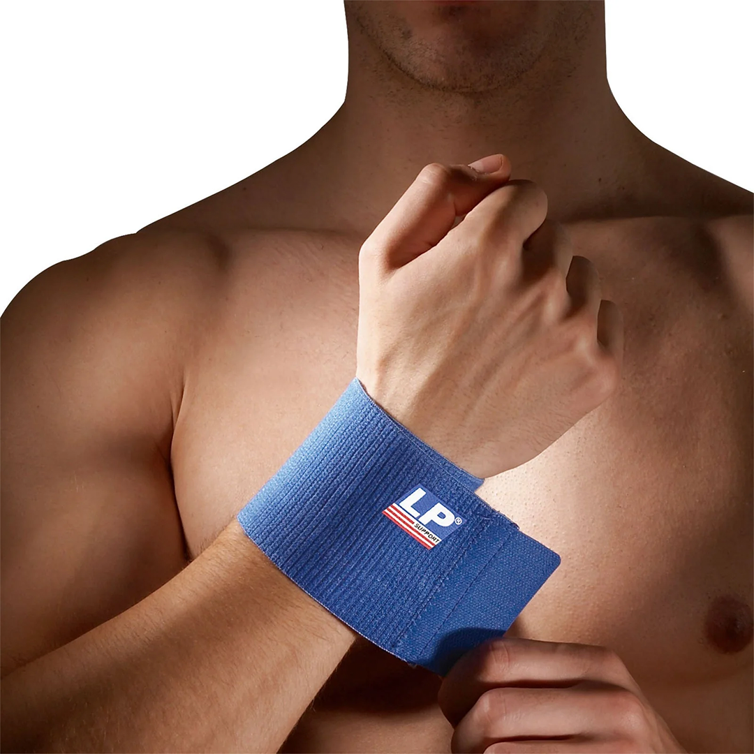 Man wearing a blue wrist support with a logo on his wrist against a white background