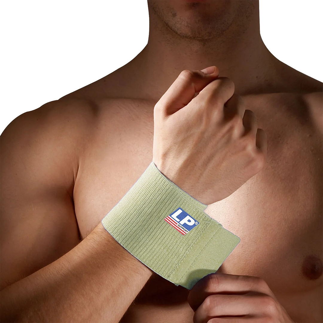 Man wearing a blue wrist support with a logo on his wrist against a white background