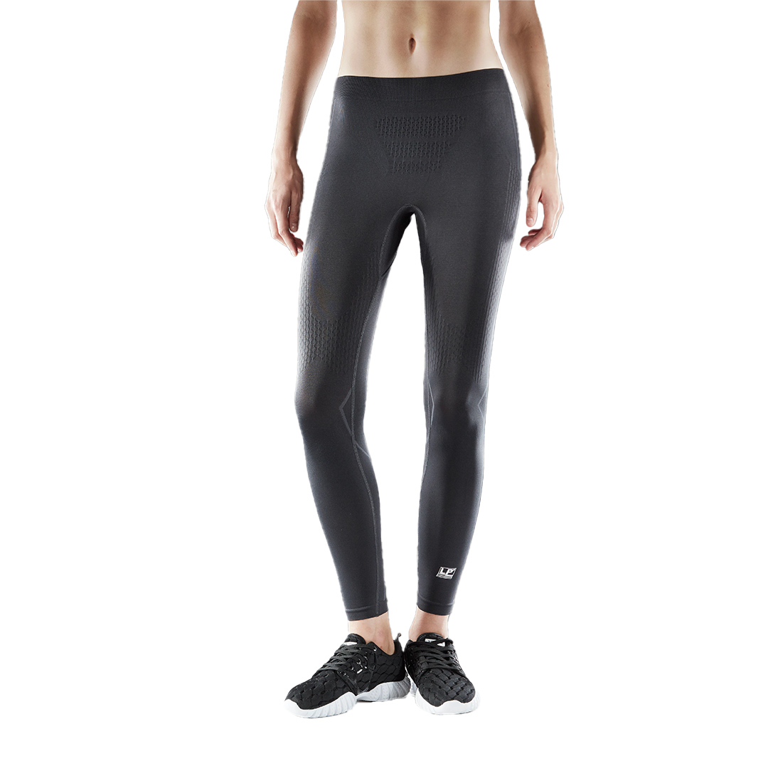 Person wearing black athletic leggings on a white background