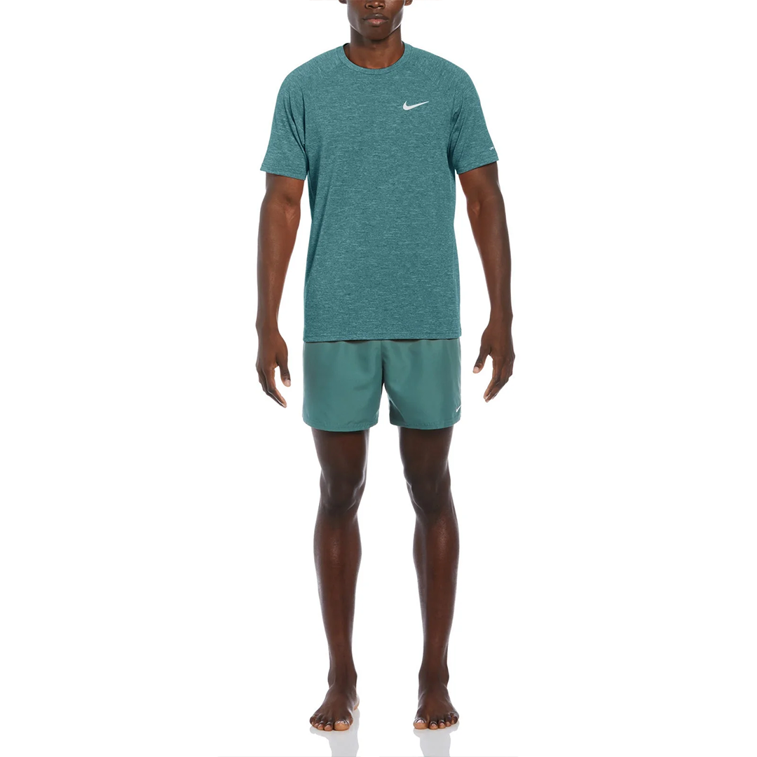 Man wearing a green Nike outfit on a white background